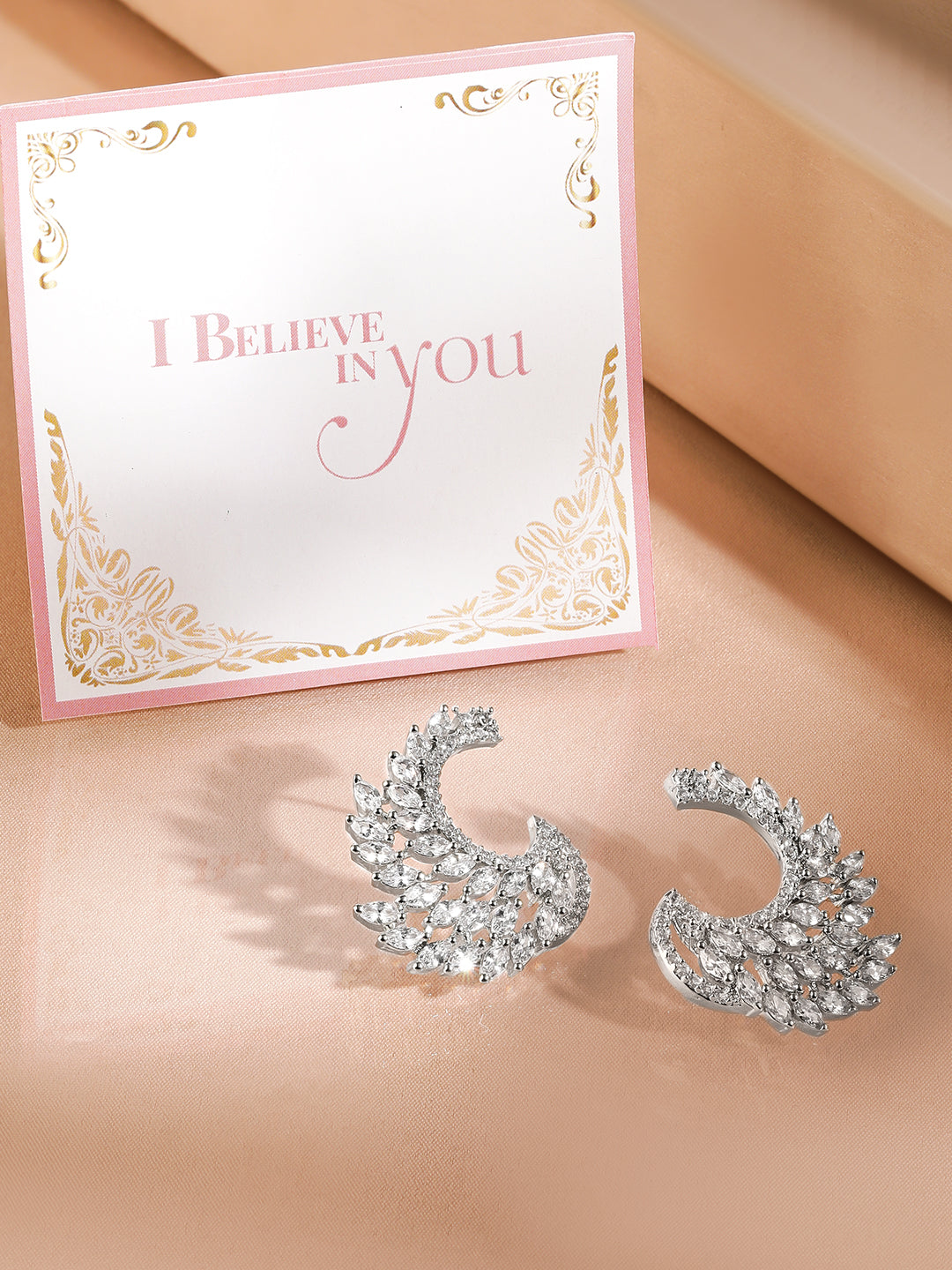 Rubans Rhodium Plated White Cubic Zirconia Studded Handcrafted Feather Shaped Statement Stud Earrings